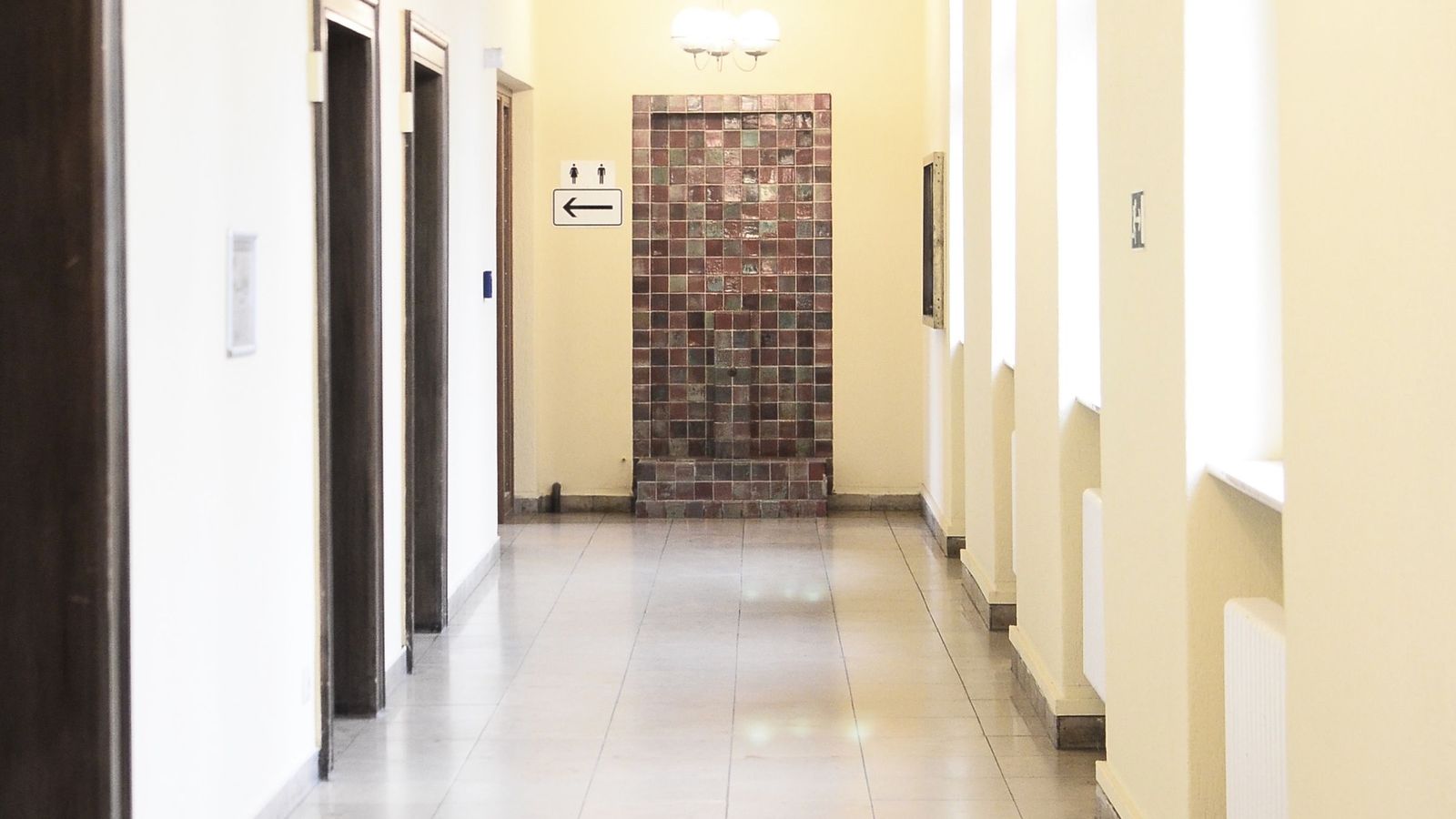A bright corridor with doors on both sides
