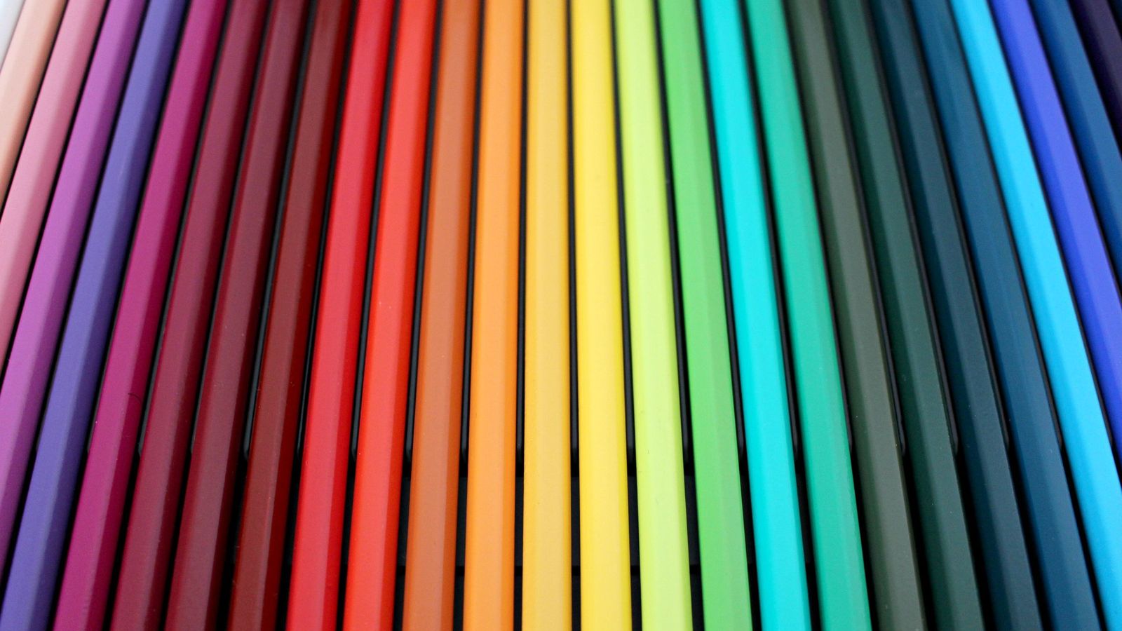 A row of coloured pencils in every colour of the rainbow